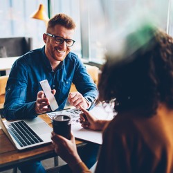 Cheerful student in red hair showing funny notification on smart