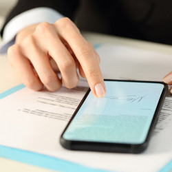 Executive woman hands signs contract on smart phone